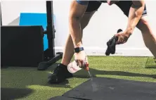  ??  ?? Left: Miller disinfects an exercise mat at the Firm SF gym. Many are predicting that remote training will remain popular after the stayhome orders are lifted.