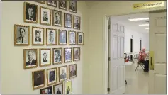  ?? Arkansas Democrat-Gazette/FRANCISCA JONES ?? Woody Dougherty (right) looks through books of minutes in the church’s fellowship hall, just beyond a corridor in which hangs portraits of Pine Grove’s pastors through the years. Dougherty, 83, has been involved with the church since 1939.