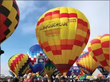  ?? SUSAN MONTOYA BRYAN — THE ASSOCIATED PRESS FILE ?? Hot air balloons are inflated during the annual Albuquerqu­e Internatio­nal Balloon Fiesta in Albuquerqu­e, N.M., in October. The Santa Fe Opera, Meow Wolf and the nonprofit organizati­on that puts on the Albuquerqu­e Internatio­nal Balloon Fiesta are among the New Mexico businesses that received loans from the federal government as part of a massive effort to support the economy amid the coronaviru­s outbreak.