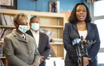  ?? PAT NABONG/SUN-TIMES ?? Chicago Public Schools CEO Janice Jackson speaks while Mayor Lori Lightfoot looks on during a news conference Tuesday at Dr. Martin Luther King Junior Academy of Social Justice in Englewood.