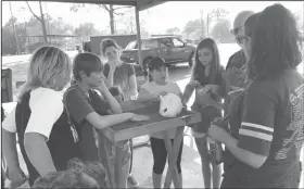  ??  ?? Rabbit Care: Recently, 4-H volunteer and rabbit breeder, Tommy Roland, taught Norphlet 4-H about rabbit care, breeds and rabbit shows.