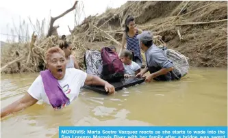  ??  ?? MOROVIS: Marta Sostre Vazquez reacts as she starts to wade into the San Lorenzo Morovis River with her family after a bridge was swept away by Hurricane Maria. — AP