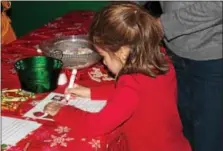  ??  ?? Children write letters to Santa in Santa’s Workshop.