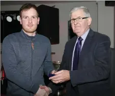  ??  ?? Duhallow Board Chairman Joe Kearns presenting Junior Hurling Team Captain Wesley Corkery with his medal.