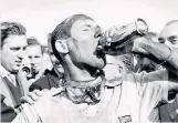  ??  ?? Thirsty work: Stirling Moss after his 1957 British GP win