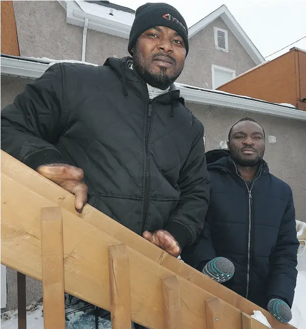  ?? KEVIN KING / POSTMEDIA NEWS ?? Razak Iyal, left, and Seidu Mohammed in the backyard of Iyal’s apartment in Winnipeg on Wednesday. The two men from Ghana lost nine fingers between them after walking across the United States/Canada border last Christmas Eve.