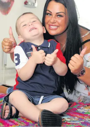  ??  ?? Thumbs up Bobby and mum Whitney are overjoyed at the news that the youngster has beaten cancer after three long years of hospitals and treatment