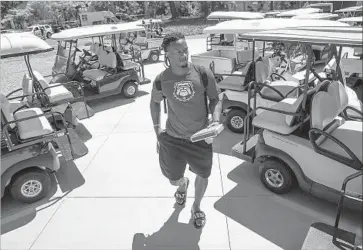  ?? Robert Gauthier Los Angeles Times ?? RUNNING BACK Todd Gurley heads to the locker room after arriving from the dorm in a golf cart before the Rams’ first day of training camp at UC Irvine. The Rams hope the carts will lessen the load on players’ legs.