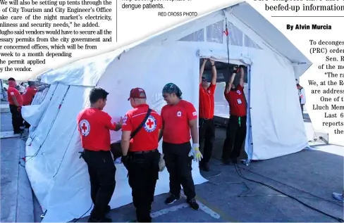  ?? RED CROSS PHOTO ?? Always ready Red Cross personnel set up a tent to help decongest hospitals of dengue patients.