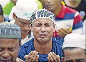  ?? AFP ?? An ethnic Rohingya Muslim refugee breaks down during a gathering in Kuala Lumpur yesterday against the persecutio­n of the group in Myanmar.
