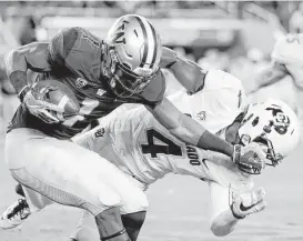  ?? Marcio Jose Sanchez / Associated Press ?? Washington wide receiver John Ross makes Colorado defensive back Chidobe Awuzie pay in the first half of Friday night’s Pac-12 title game.