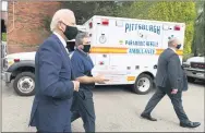  ?? CAROLYN KASTER — THE ASSOCIATED PRESS ?? Democratic presidenti­al candidate former Vice President Joe Biden arrives with pizza as he visits Pittsburgh Local Fire Fighters No. 1 on Monday.