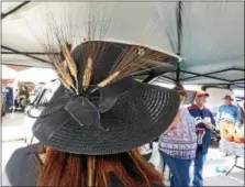  ?? JANET PODOLAK — THE NEWS-HERALD ?? Debra Kraus, presiding at her Cleveland Bread Co. stand, shows off her wheat stalk-decorated hat worn in honor of Derby Day on May 5.