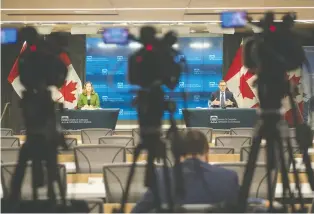  ?? ADRIAN WYLD/ THE CANADIAN PRESS FILES ?? Bank of Canada governor Tiff Macklem, right, is playing it safe by opting this week to leave interest rates and bond-buying strategies unchanged, says Kevin Carmichael.