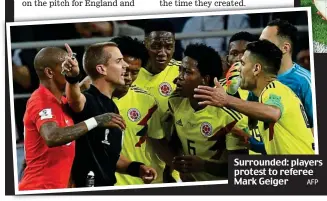  ?? AFP ?? Surrounded: players protest to referee Mark Geiger