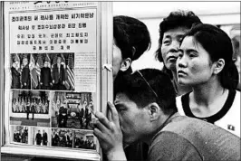  ?? MINORU IWASAKI/KYODO NEWS ?? North Koreans look Wednesday at a display of government reports on Tuesday’s summit.