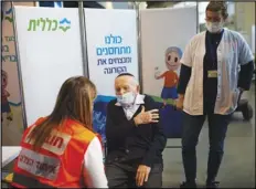  ?? AP FILE PHOTO ?? In this Jan. 21 file photo, Holocaust survivor Joseph Zalman Kleinman gestures to the arm he prefers to receive the second dose of the Pfizer vaccine for COVID-19, in Jerusalem.