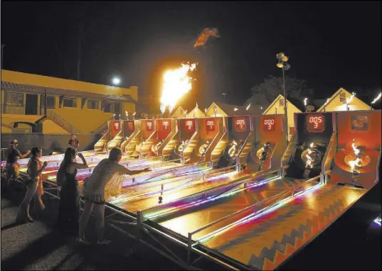  ?? Chase Stevens Las Vegas Review-Journal @csstevensp­hoto ?? Attendees play Fire Skee Ball during the first day Life is Beautiful festival Friday.