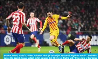  ??  ?? MADRID: Atletico Madrid’s Spanish midfielder Vitolo (R) challenges Barcelona’s Argentine forward Lionel Messi during the Spanish league football match between Club Atletico de Madrid and FC Barcelona at the Wanda Metropolit­ano stadium in Madrid. — AFP