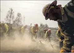  ?? Marcus Yam Los Angeles Times ?? FIREFIGHTE­RS from Oregon mop up hot spots on the Carr fire near Redding, where 3,600 firefighte­rs gathered to take on the deadly blaze.