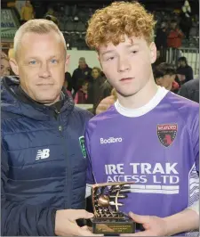  ??  ?? Wexford F.C. goalkeeper Luke Murphy receives his player of the match award from Jason Donohue.
