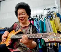  ?? AFP ?? Mary Ho, also known as Grandma Mary, posing with her electric guitar during a rehearsal in Singapore. —