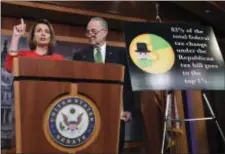  ?? SUSAN WALSH — THE ASSOCIATED PRESS ?? House Minority Leader Nancy Pelosi of Calif., left, standing with Senate Minority Leader Sen. Chuck Schumer of N.Y., right, speaks at a news conference on Capitol Hill in Washington, Wednesday on the passage of legislatio­n that overhauls U.S. tax law....