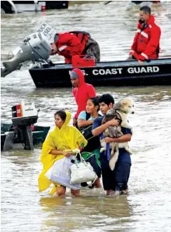  ?? THE ASSOCIATED PRESS ?? Evacuees wade down Tidwell Road after being evacuated from their homes as floodwater­s from Tropical Storm Harvey rise Monday in Houston.