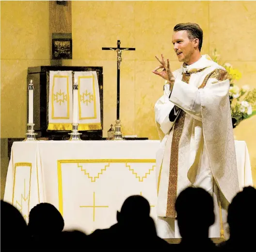  ?? ALEX KORMANN STAR TRIBUNE ?? The Rev. Andrew Brinkman speaks to parishione­rs during Mass at Our Lady of Guadalupe Catholic church in St. Paul, Minn., last year.