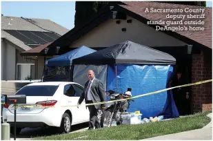  ??  ?? A Sacramento County deputy sheriff stands guard outside DeAngelo’s home