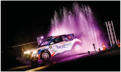  ?? Photograph: Bastien Roux/ LiveMedia/Shuttersto­ck ?? Drivers are lit up at the trophy presentati­on after the European Rally Championsh­ip’s recent stage in Hungary.
