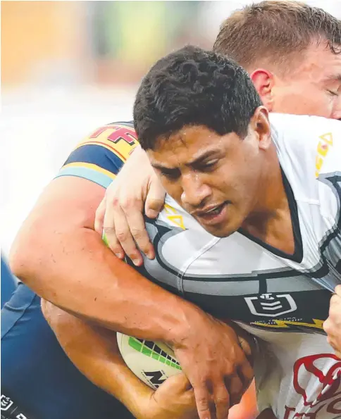  ??  ?? Titans prop Jarrod Wallace (right) wraps up North Queensland’s Jason Taumololo in yesterday’s loss at Cbus Super Stadium.