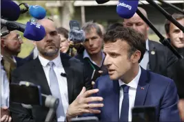  ?? JEAN-FRANCOIS BADIAS — THE ASSOCIATED PRESS ?? French President Emmanuel Macron speaks with supporters and medical staff as he visits Alister, a training center for functional rehabilita­tion, in Mulhouse, eastern France, on Tuesday.