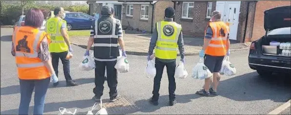  ??  ?? ■ Volunteers out helping the vulnerable.