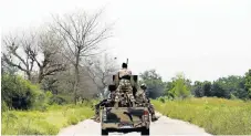  ?? /Reuters ?? Hot spot: A file picture shows a military vehicle driving along the KondugaBam­a road in Bama, in Borno state, in 2016.