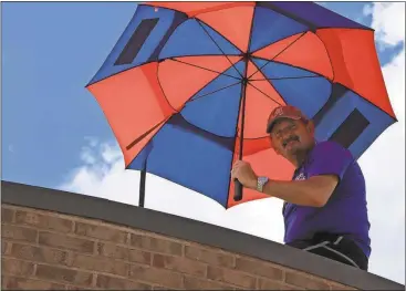  ?? Kristina Wilder / Rome News-Tribune ?? Armuchee Elementary School Principal Rodney Stewart smiles as he hangs out on the roof of his school.