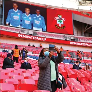  ??  ?? What a shot: A supporter takes a photo at Wembley Stadium yesterday