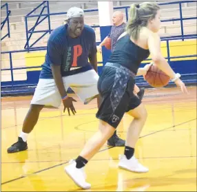  ?? Westside Eagle Observer/MIKE ECKELS ?? While Jeremy Schopper (background) works with a junior high player, Fess Thompson (left) runs Abby Tilley through a drill during an off-season practice session at Peterson Gym in Decatur Aug. 7. Thompson coached the Lady Bulldogs to their first state tournament appearance in 20 years during the 2018-19 basketball season.