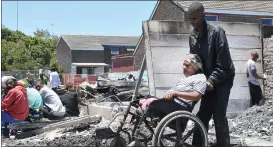  ?? Picture: Bheki Radebe/African News Agency (ANA) ?? DESTITUTE: Esmeralda van Wyk is assisted by Damike van Wyk after a fire swept through the 7th Avenue informal settlement.