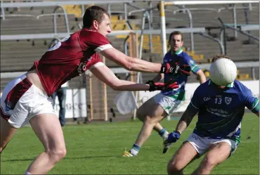  ??  ?? Barry Doyle of Glynn-Barntown is hidden behind the ball as Jamie Carty of St. Martin’s attempts to make tracks.