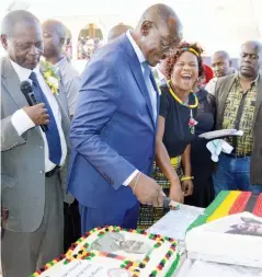  ??  ?? Vice-President Kembo Mohadi (second from left) cuts a cake during celebratio­ns to mark his appointmen­t as country’s Vice-President in Gwanda yesterday. Looking on is the Minister of State for Provincial Affairs for Matabelela­nd South, Cde Abednico...