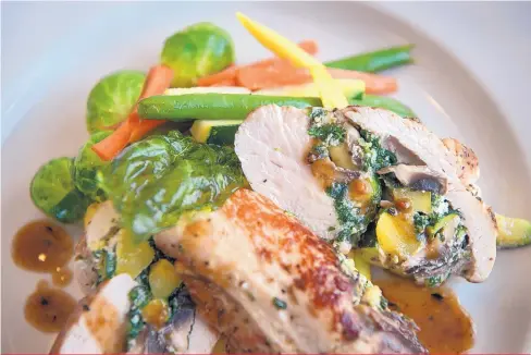  ?? EDDIE MOORE/JOURNAL ?? The stuffed grilled chicken breast at Cafe Grazie includes spinach, mushrooms and more.