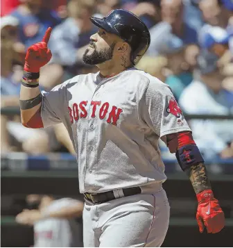  ?? AP PHOTO ?? DEEP MEANING: Sandy Leon gestures skyward after belting a two-run home run in the fourth inning of the Red Sox' 4-0 victory against the Mariners yesterday.
