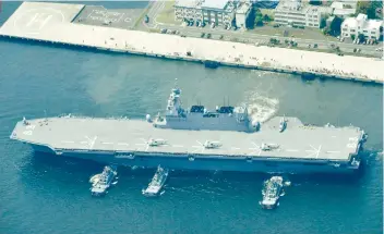  ?? KYODO NEWS VIA AP ?? DRILL. Helicopter carrier Izumo departs Yokosuka port on Monday amid rising tension following missile tests by North Korea. Japan’s largest destroyer is escorting U.S. military ships.