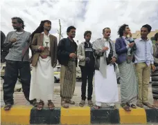  ?? EPA ?? Bahais hold flowers during a protest against the trial of Hamed Haydara outside the state security court in Sanaa