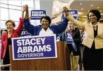 ?? ALYSSA POINTER / ALYSSA.POINTER@AJC.COM ?? Georgia Democratic gubernator­ial candidate Stacey Abrams links hands with U.S. Senator Elizabeth Warren (left) and newly-elected U.S. Representa­tive Ayanna Pressley (right) during a rally at Clayton State University on Tuesday.