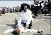  ?? PICTURE: AP ?? Township residents and children re-enact the 27th anniversar­y of the Soweto uprising when police opened fire on students protesting against the use of Afrikaans as the medium of instructio­n in schools.