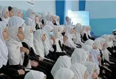  ?? — AFP file photos ?? Afghan school girls sit in a classroom as the new academic year begins in Kandahar on Sept 7, 2022.