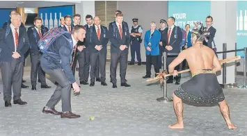  ??  ?? British and Irish Lions rugby team captain Sam Warburton accepts the challenge and picks up the dart as he and the rest of the squad receive a traditiona­l Maori welcome upon their arrival at the airport in Auckland. — AFP photo
