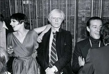  ??  ?? Celebratin­g the first anniversar­y of Studio 54 in New York on April 26, 1978, are, from left, Liza Minnelli, Andy Warhol and Halston. Mr. Warhol died after what was widely believed to be routine surgery, but John Ryan, a medical historian and retired surgeon, said it was major surgery “in a very sick person,” and his death shouldn't have been that much of a surprise.